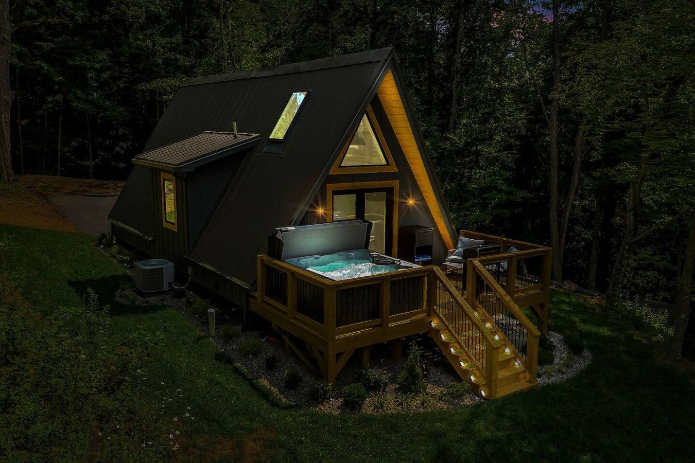 XL deluxe hot tub on the High Peak deck at night
