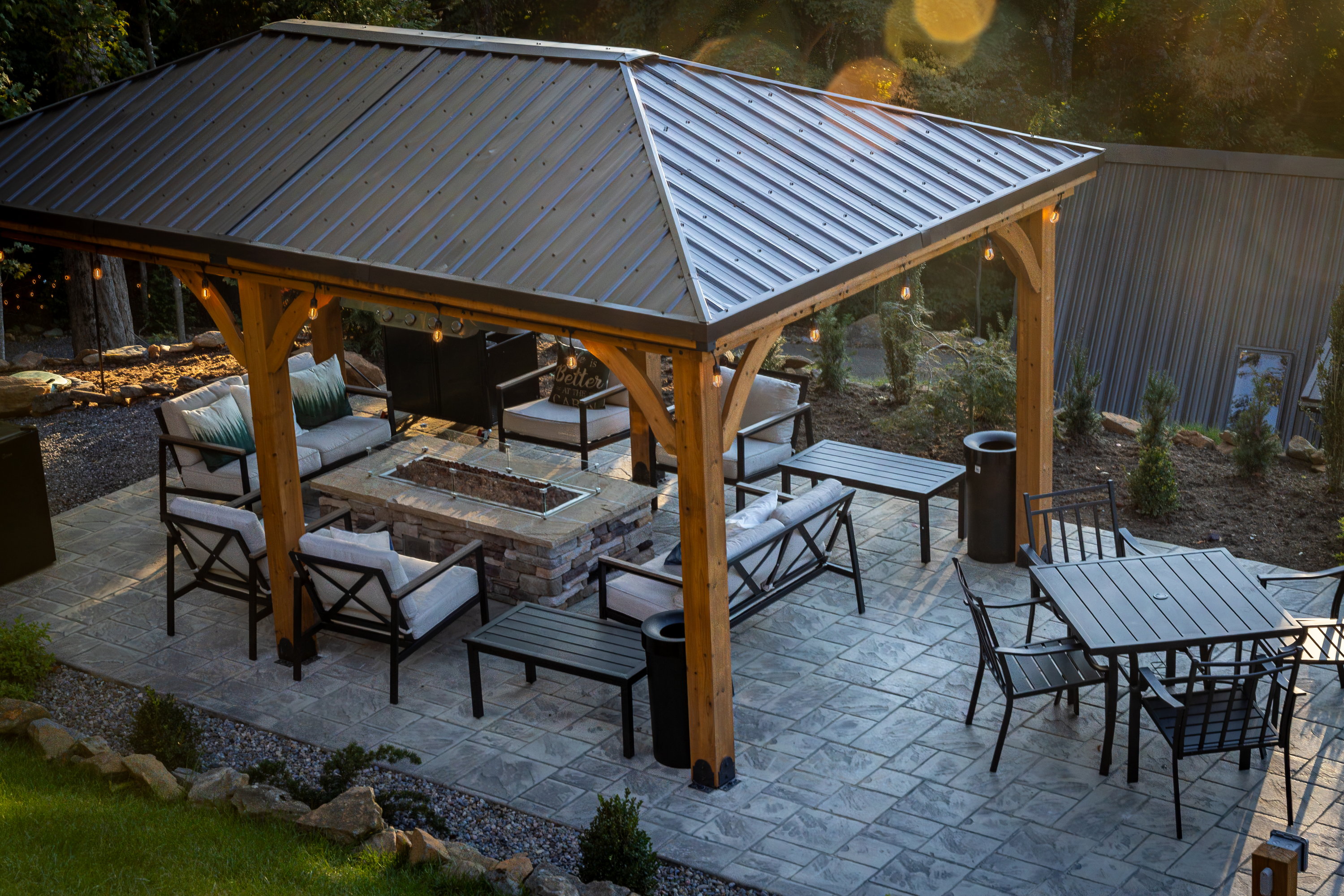 Daytime covered pavilion and gas-fueled stone fire pit at High Peak in West Jefferson, NC.